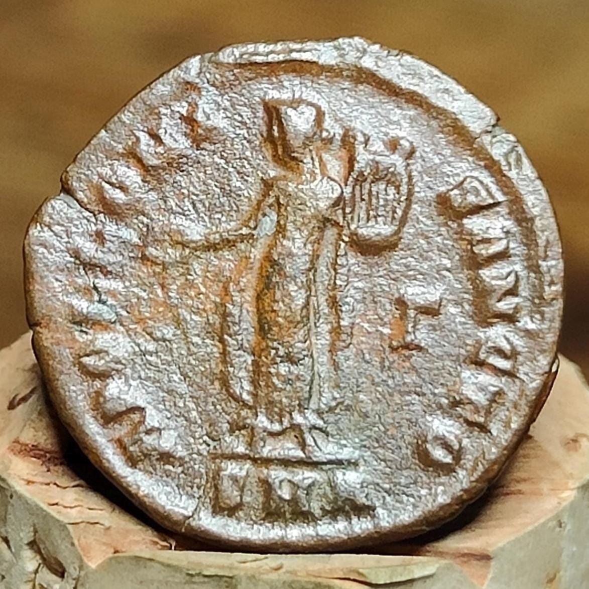 Christian persecution issue roman coin featuring Apollo and Genius
