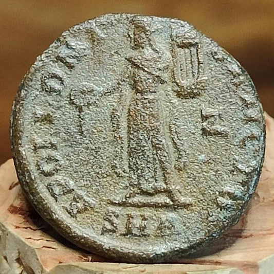 Christian persecution issue roman coin featuring Apollo and Genius